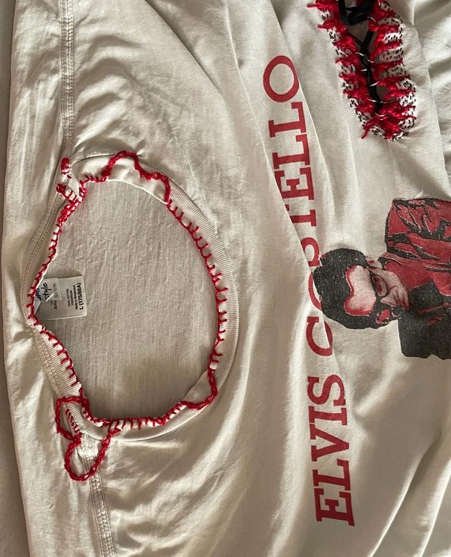 In the top right, you can see a more sealed style of the elastic corset, but the main feature here is the neckline mending done with red embroidery thread. I didn't just want to loop around the edges so I changed to a honeycomb stitch to make some loops into the shirt, eventually making the heart and patching up any nearby tears.